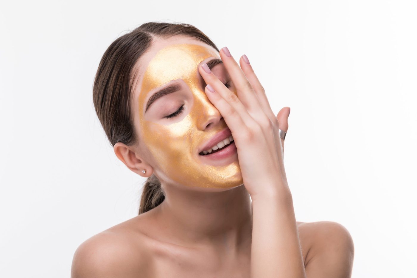 close up healthy young woman with gold cosmetic face mask soft skin scaled e1655891500146