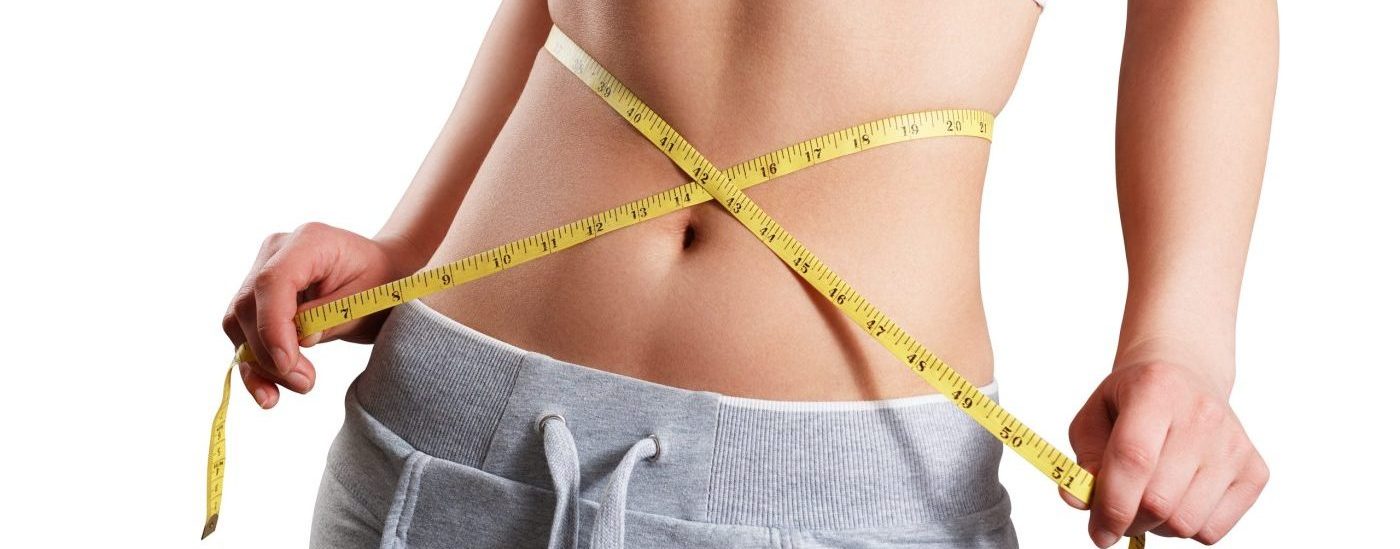 close up slim woman measuring her waist s size with tape measure scaled e1655969464572